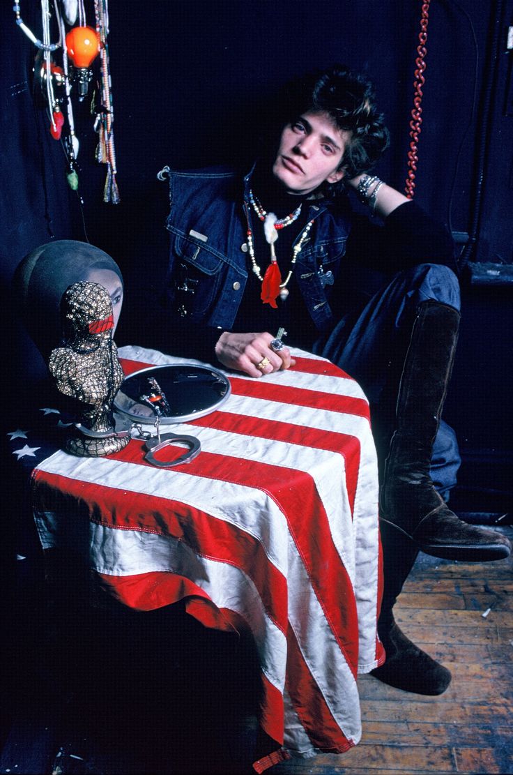 a man sitting at a table with a skull on it