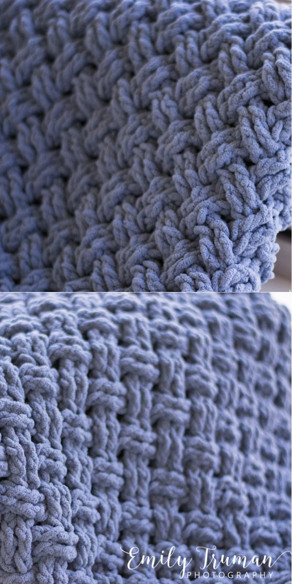 a blue crocheted blanket sitting on top of a bed