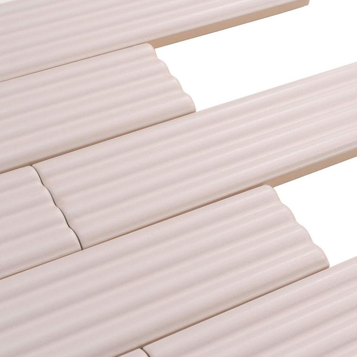 the top part of a white plastic slatted window