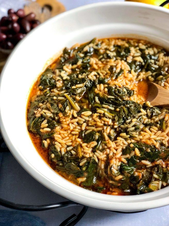 a white bowl filled with rice and spinach