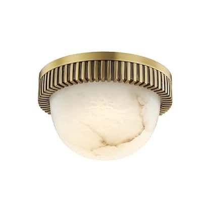 a light fixture with a white glass shade on the top and gold trim around it