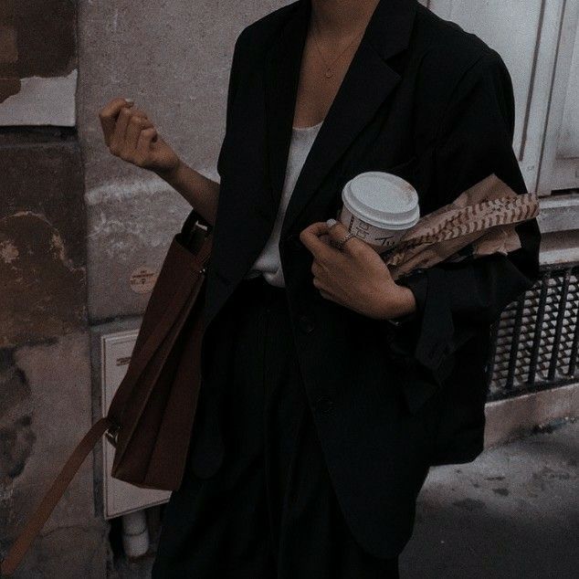 a woman holding a coffee cup in her hands