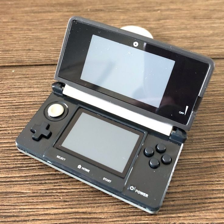 an electronic device sitting on top of a wooden table