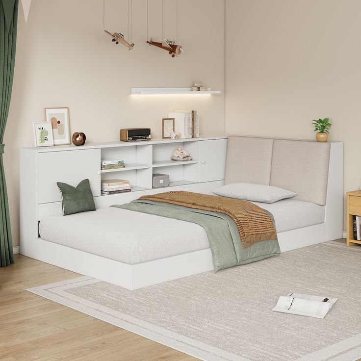 a white bed sitting on top of a hard wood floor next to a book shelf