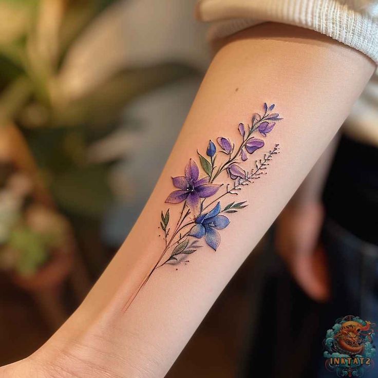 a woman's arm with purple flowers on it