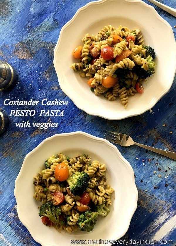 two white bowls filled with pasta and vegetables