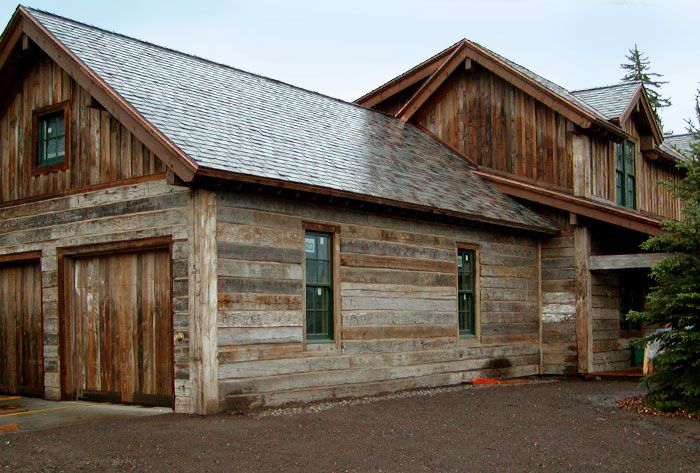 an old wooden building with two garages