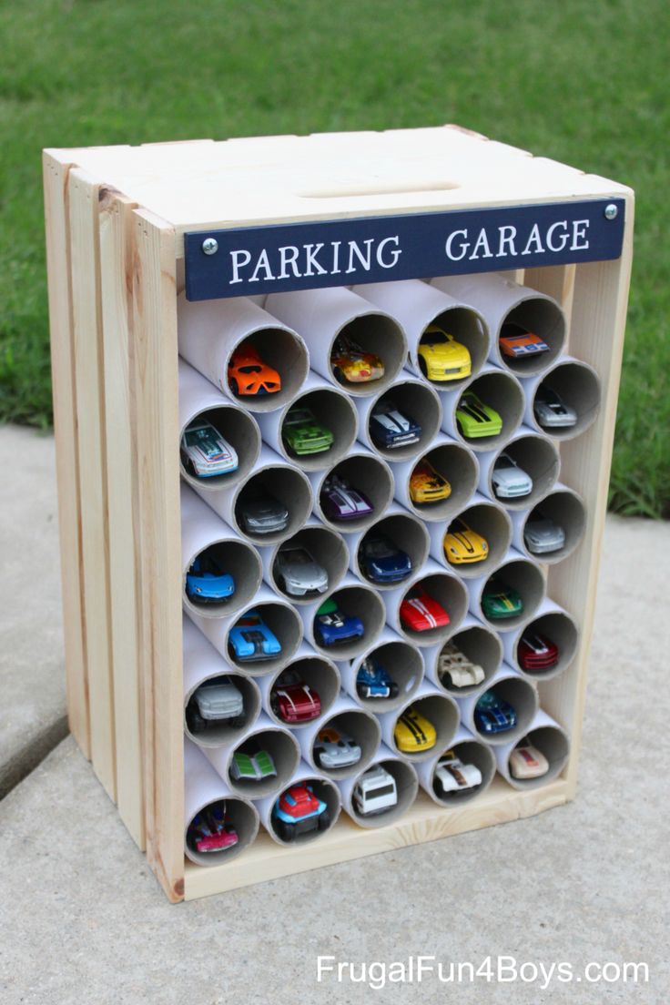 a wooden parking garage organizer filled with lots of different types of car parts on it