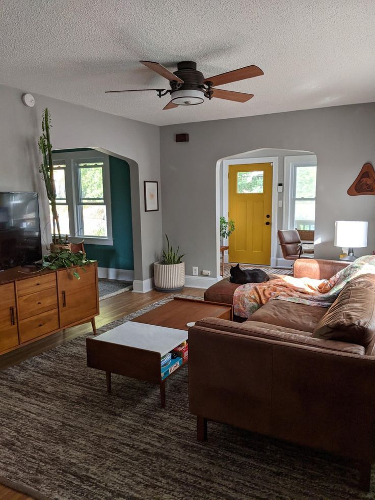 a living room filled with furniture and a flat screen tv