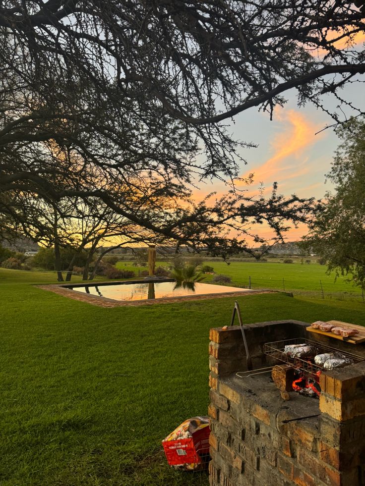 an outdoor bbq in the middle of a grassy field