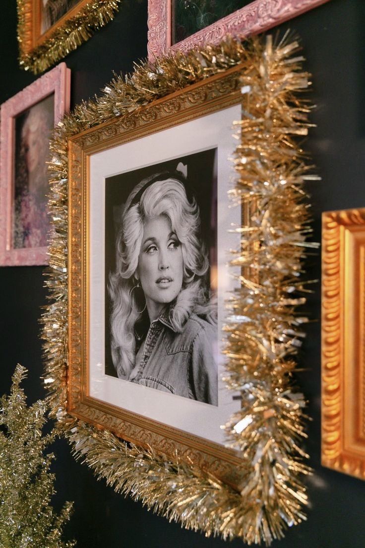 there are pictures on the wall with tinsel