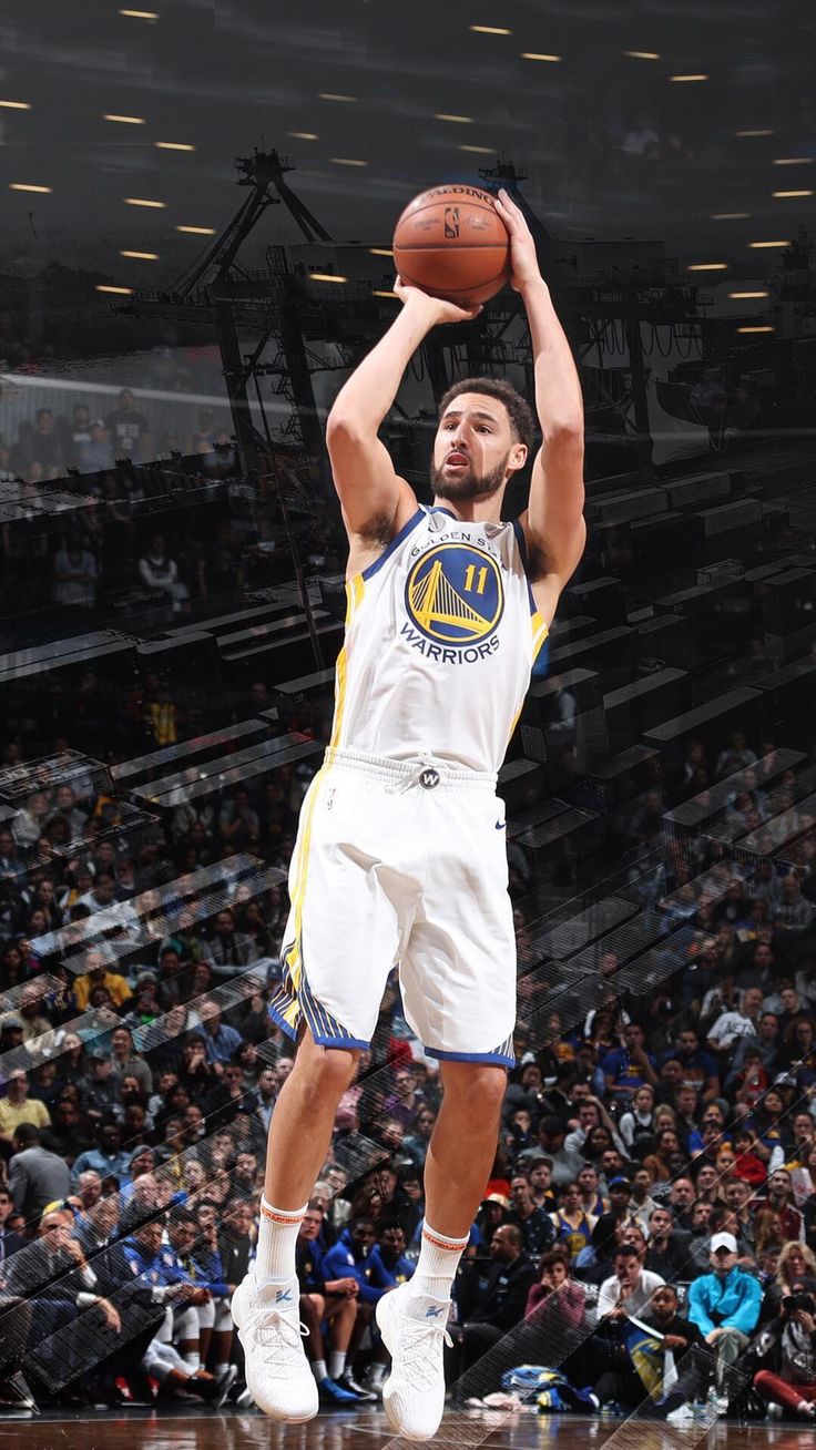 a basketball player is getting ready to dunk the ball in front of an audience