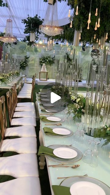 a long table is set with plates and place settings