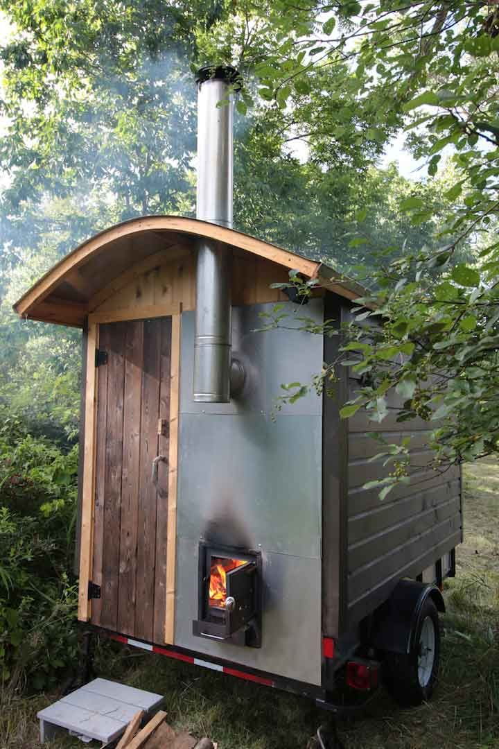 a small wood burning stove in the back of a trailer