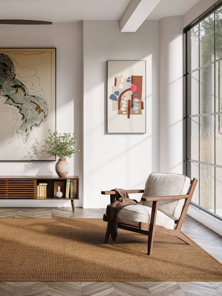 a living room filled with furniture and art on the wall next to a large window