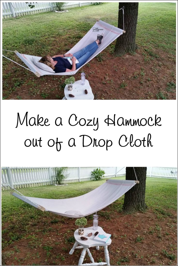 a hammock that is sitting in the grass with a person laying on it