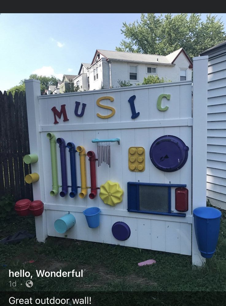 there is a sign that says music with many different things on it in the yard