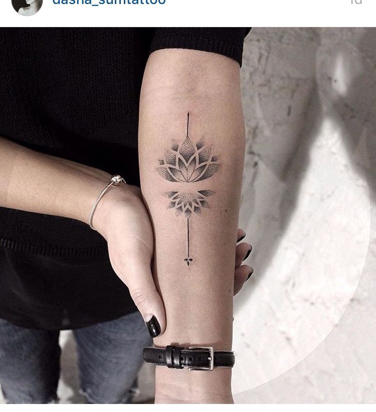 a woman's arm with a tattoo on it and a flower in the middle