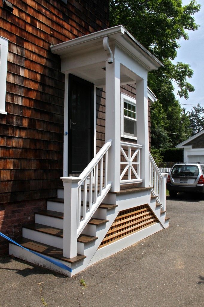 a small house with steps leading up to the front door