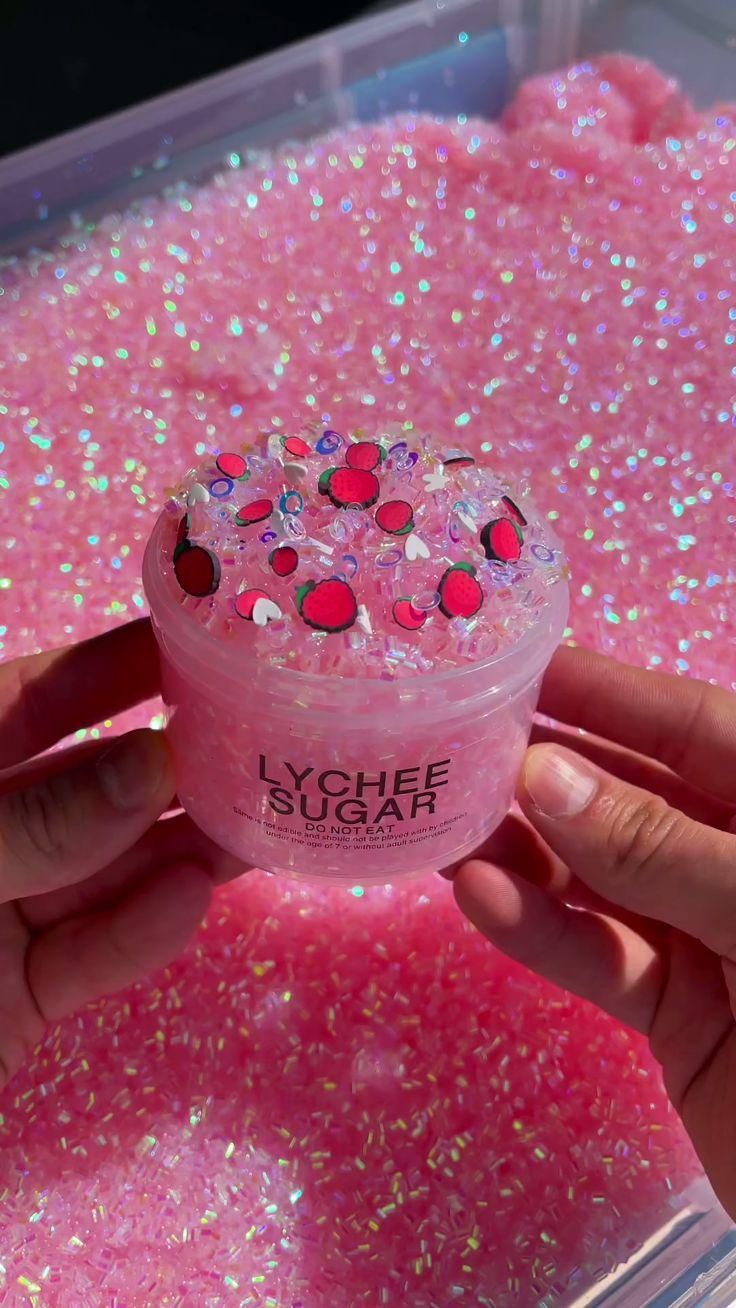 someone is holding up a pink gel with lots of sprinkles