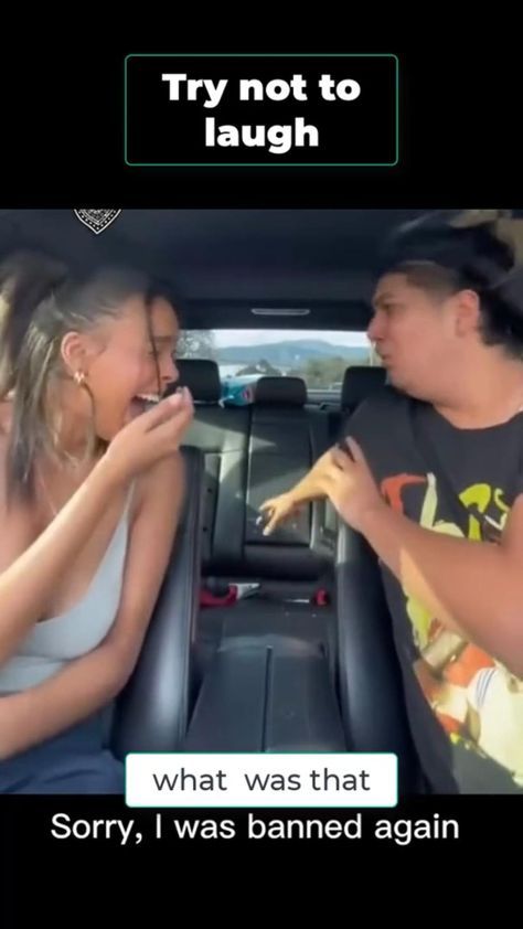 a man and woman sitting in the back seat of a car, one is eating