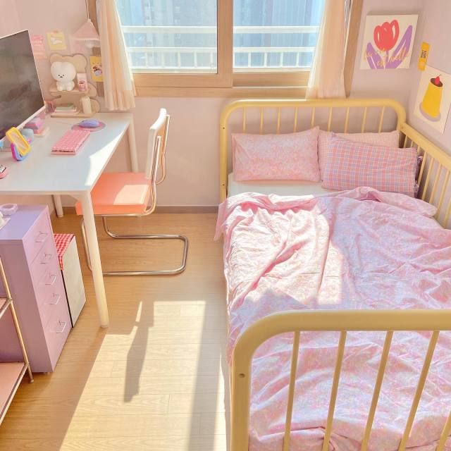 a small child's room with a bed, desk and chair