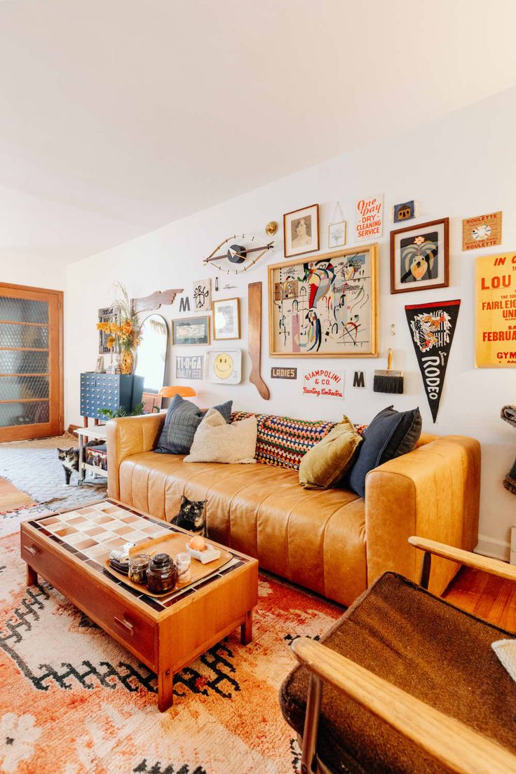 a living room filled with lots of furniture and pictures on the wall above it's coffee table