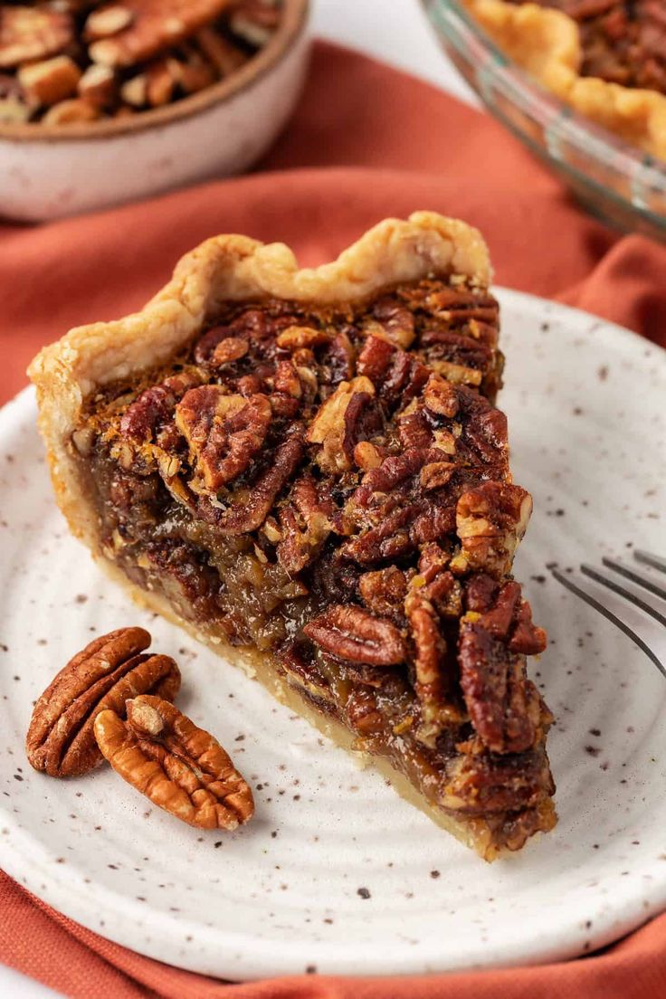 a slice of pecan pie on a plate with a fork