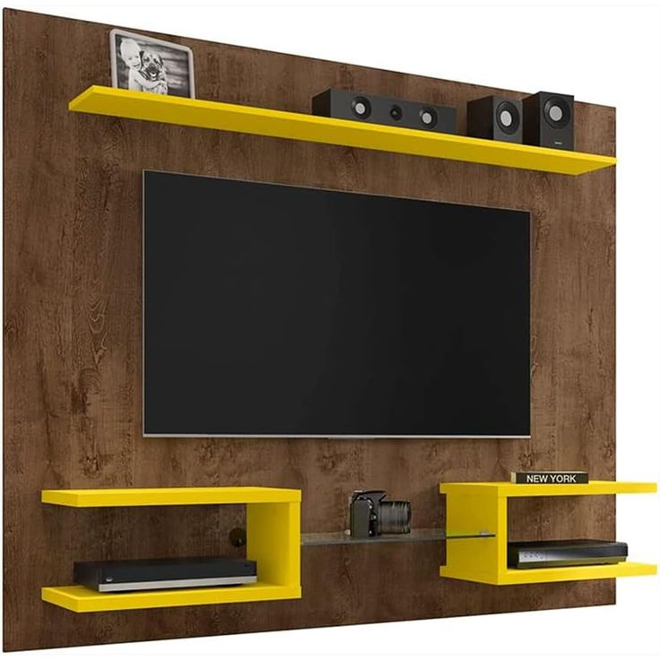 an entertainment center with yellow shelves and a flat screen tv mounted to the side of it