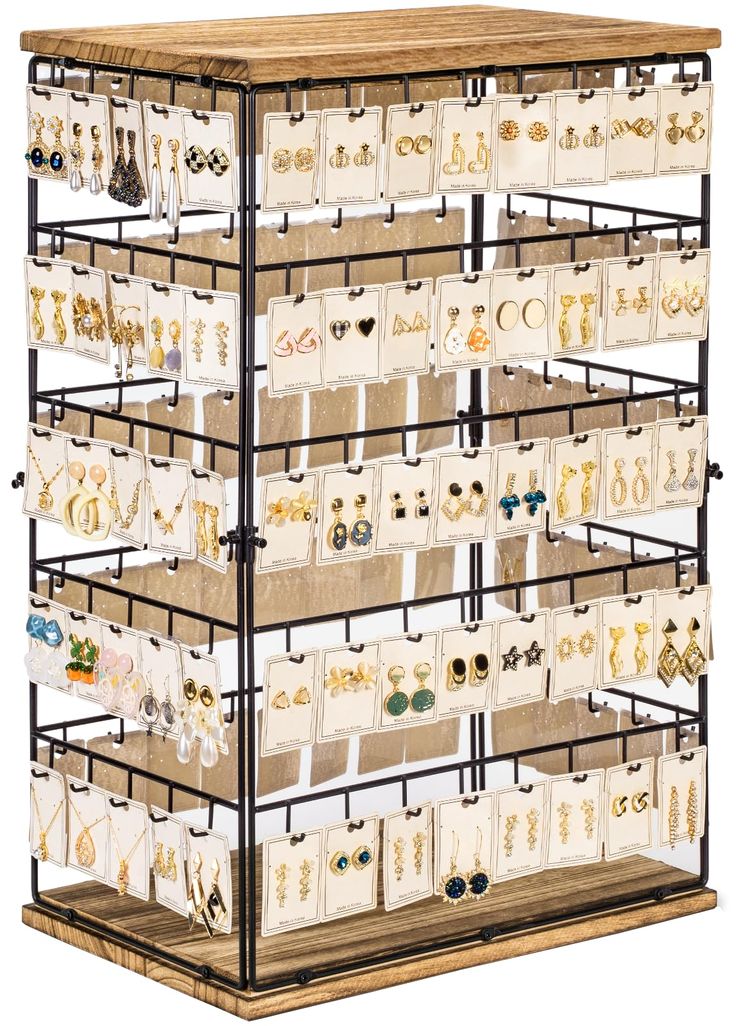 a wooden and metal jewelry rack filled with lots of necklaces on display in front of a white background