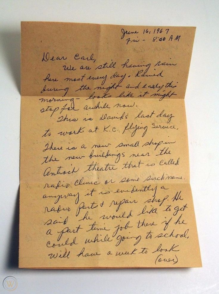 an old handwritten letter on top of a piece of brown paper with writing underneath it