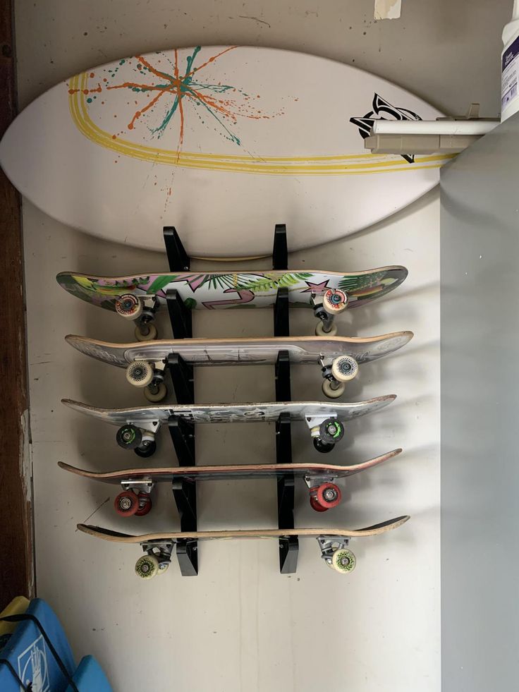 a surfboard mounted to the side of a wall with five boards attached to it