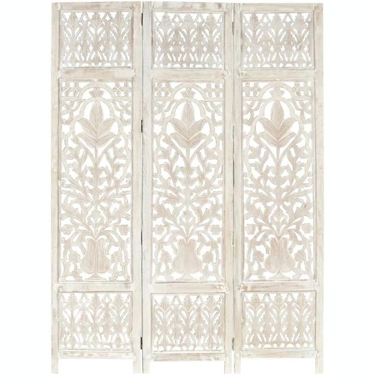 a white screen with intricate carvings on it