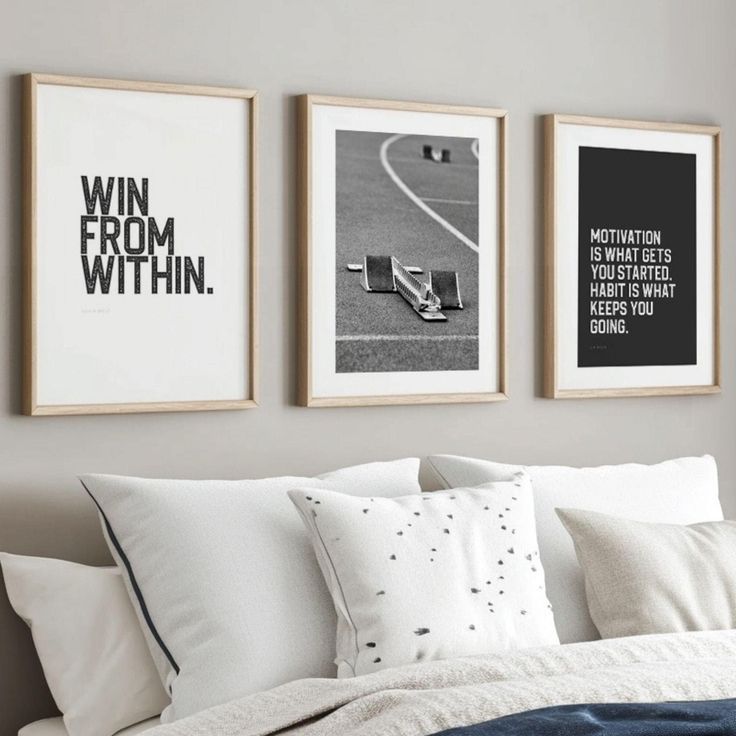 three black and white pictures hang on the wall above a bed with pillows, blankets and throw pillows