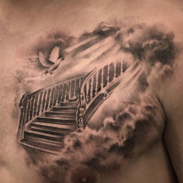 a man with a tattoo on his chest has stairs and clouds in the sky behind him