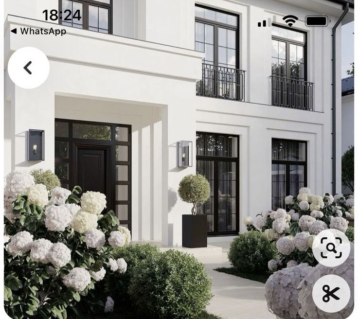 an image of a house with white flowers in the front yard