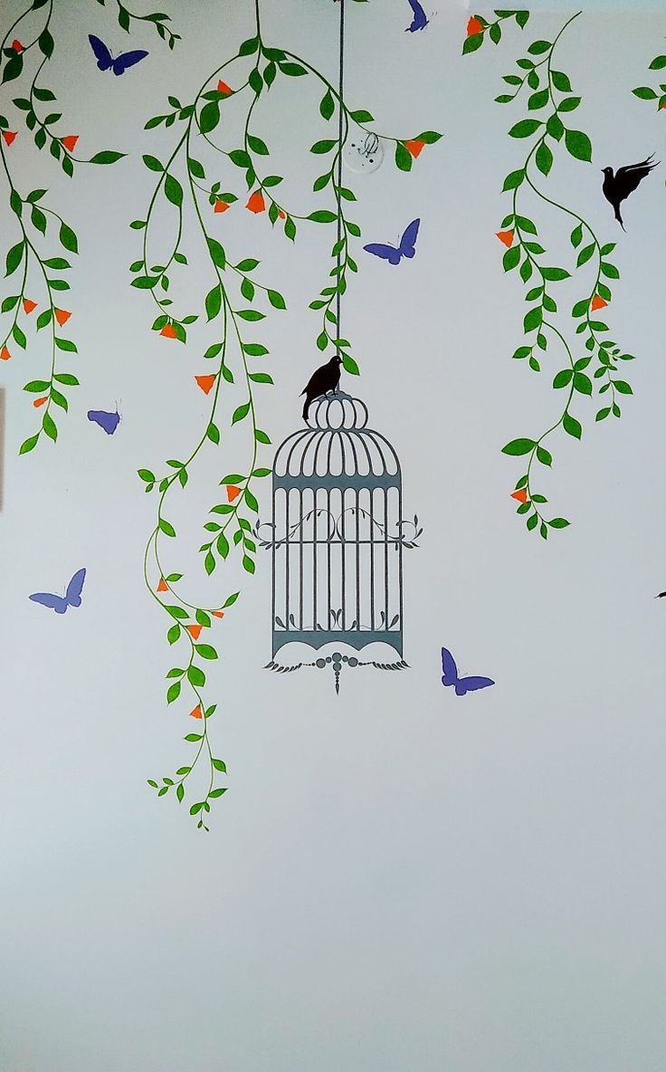 a birdcage hanging from a tree with birds flying around it and butterflies in the background