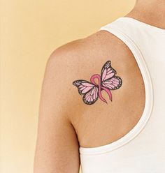 a woman with a pink butterfly tattoo on her shoulder