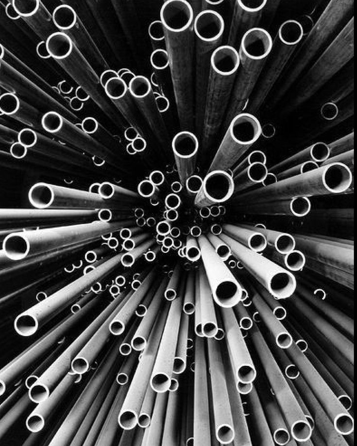 black and white photograph of many metal tubes in the shape of a starburst