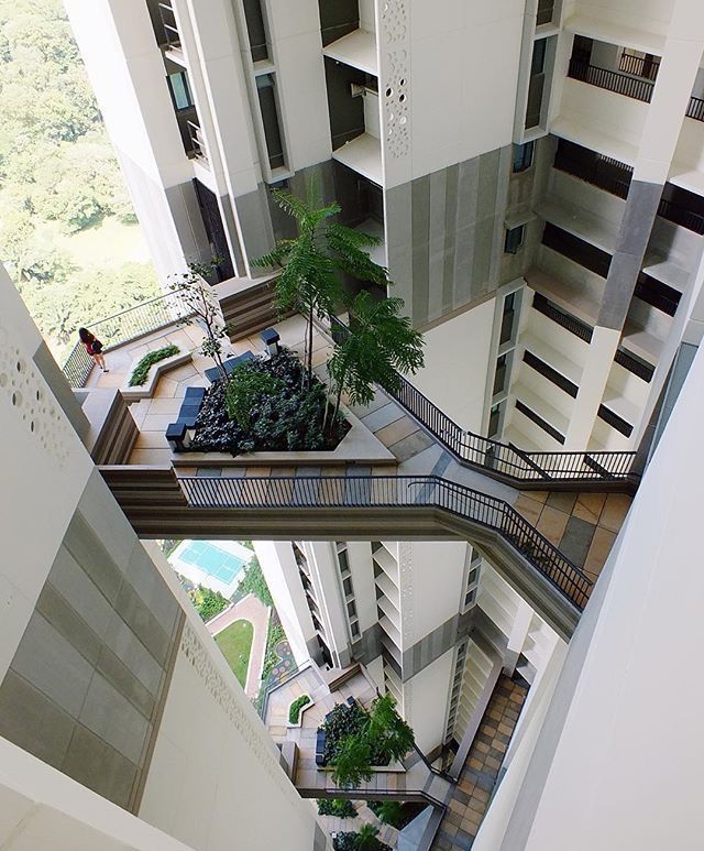 an atrium with plants and stairs leading up to the second floor in a large building