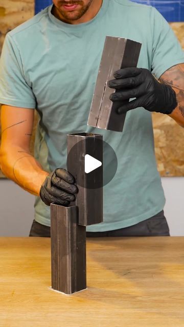 a man is working on a piece of metal that has been made into a sculpture