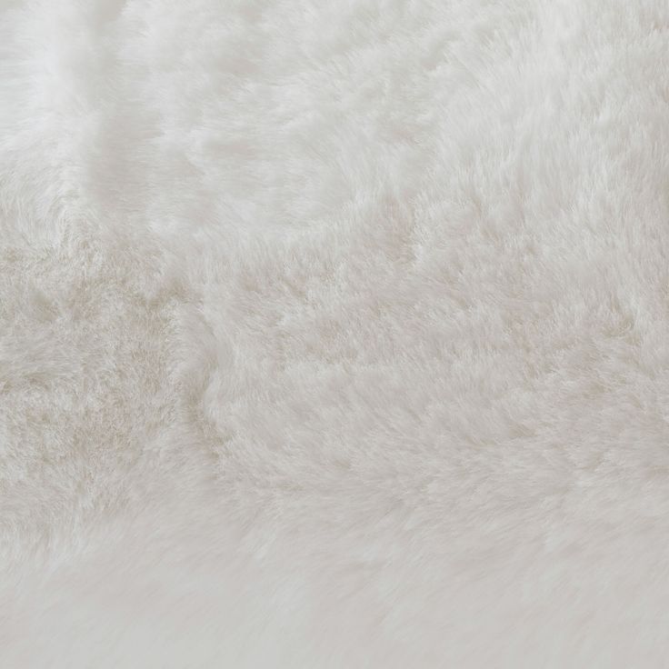 white fur textured up close to the ground for use as a background or wallpaper