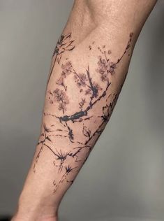 a man's leg with tattoos on it