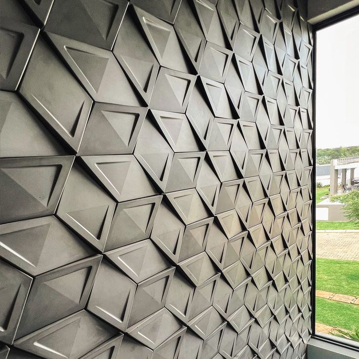 the wall is made up of many different shapes and sizes, including geometricly designed tiles