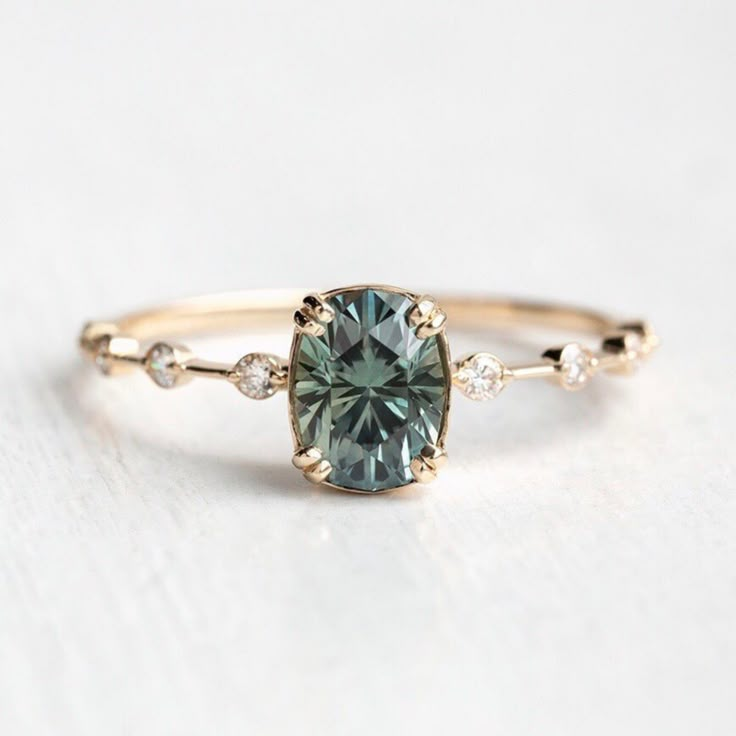 an engagement ring with a green diamond in the center