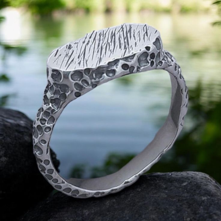 Embrace bold design with our Industrial Brutalist Hammered Ring, a unique piece of artisan jewelry that blends rugged charm with modern style. Crafted from solid silver, this rustic signet ring is perfect for both men and women who appreciate an edgy, industrial aesthetic. The hammered finish adds texture and depth, making it an ideal accessory for casual wear or as a rustic wedding ring. Whether you're drawn to industrial, brutalist, or artisan design, this ring is a timeless statement of indiv Brutalist Oxidized Finish Ring For Gift, Brutalist Sterling Silver Rings As Gift, Handmade Silver Brutalist Rings, Brutalist Hammered Silver Ring, Brutalist Sterling Silver Rings, Rustic Wedding Rings, Hammered Rings, Mens Silver Rings, Artisan Design