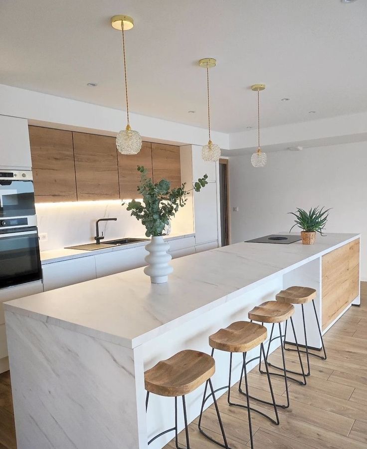 a kitchen island with four stools next to it