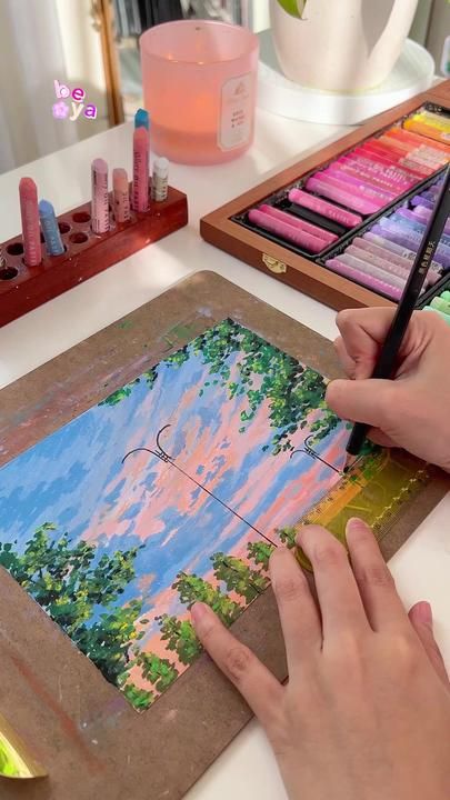 a person is painting on a canvas with watercolors