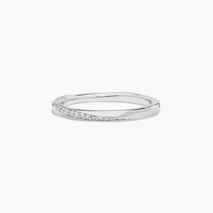 a white gold ring with small diamonds on the side, set in 18k white gold