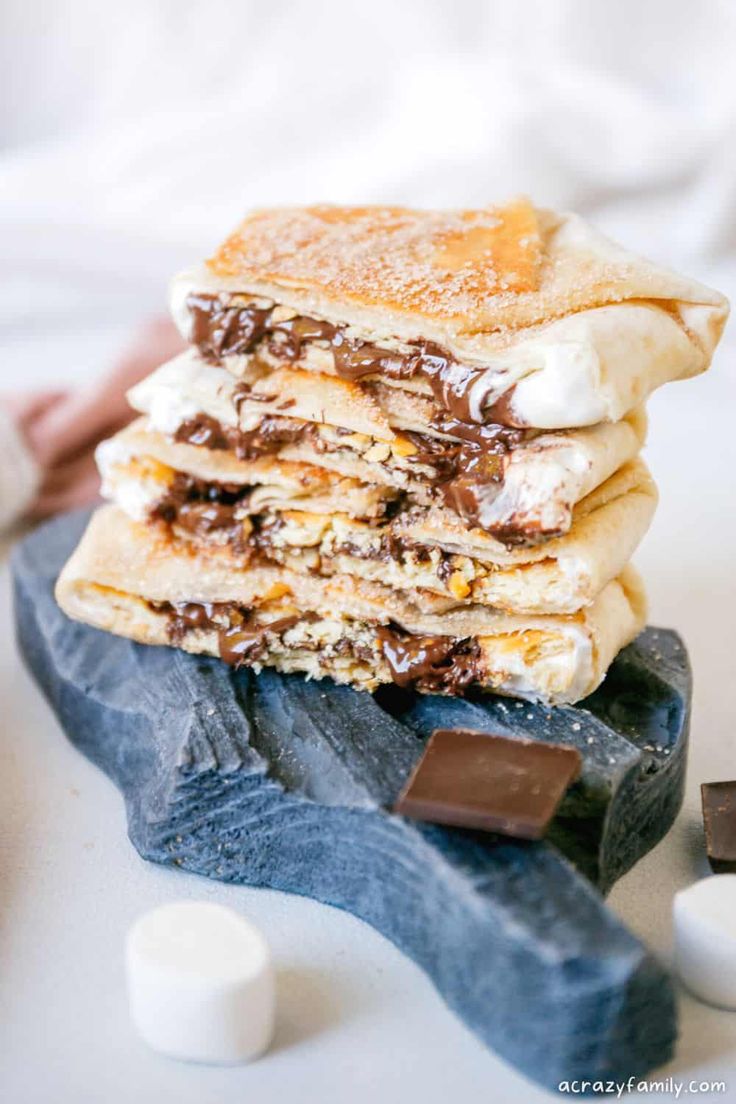 a stack of pancakes with chocolate and marshmallows